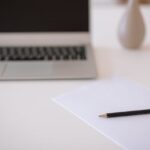 Laptop, stół, ołówek, papier